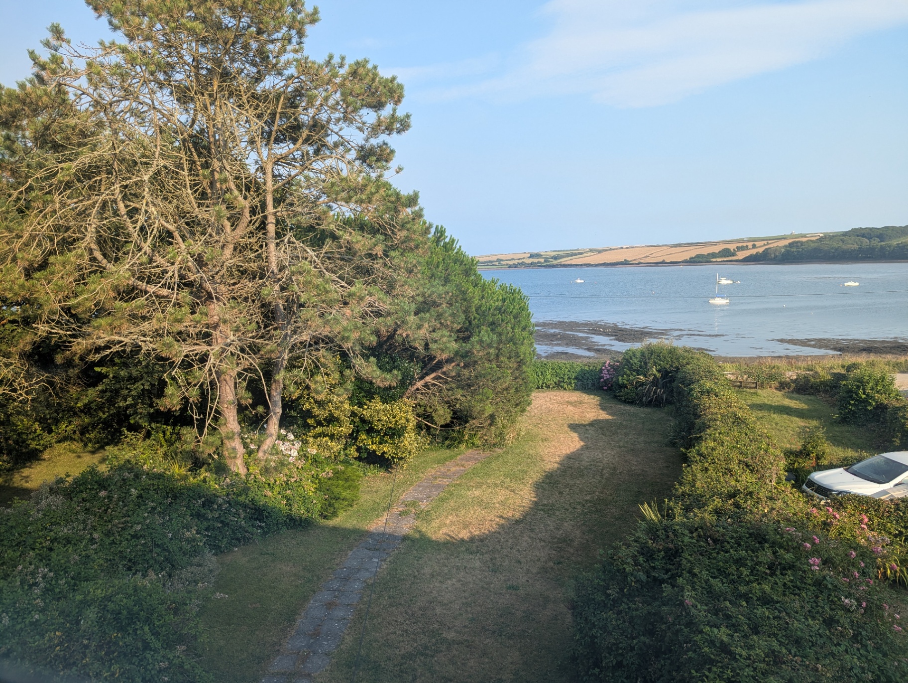 View from 4 Bay View across the garden and pine trees to East Angle Bay.
