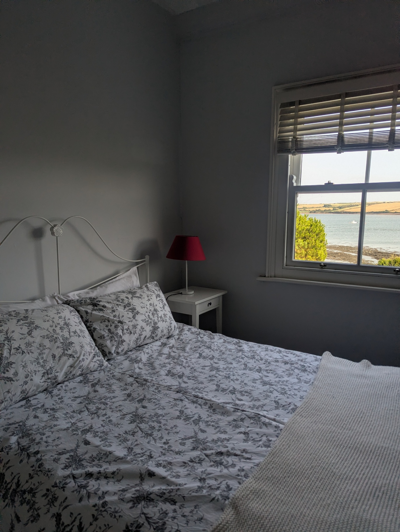 The main bedroom, with a double bed and a window looking out across the bay.